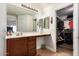 Bathroom featuring a vanity, large mirror, and adjacent closet at 8714 W Heber Rd, Tolleson, AZ 85353