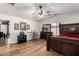 Spacious bedroom with large bed, ceiling fan, and wood-like flooring at 8714 W Heber Rd, Tolleson, AZ 85353