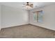 Bright bedroom with ceiling fan and window blinds at 8312 W Pioneer St, Tolleson, AZ 85353