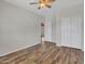 Bright bedroom with wood-look floors, double closets, and ceiling fan at 8312 W Pioneer St, Tolleson, AZ 85353
