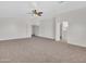 Spacious main bedroom with carpet and access to other rooms at 8312 W Pioneer St, Tolleson, AZ 85353