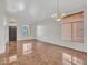 Open living room with tile floors and large window at 8312 W Pioneer St, Tolleson, AZ 85353