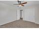 Spacious bedroom with double door closet and ceiling fan at 8312 W Pioneer St, Tolleson, AZ 85353