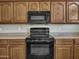 Kitchen with black appliances and wood cabinets at 8312 W Pioneer St, Tolleson, AZ 85353