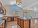 Kitchen features an island, wood cabinets, and tile flooring at 8312 W Pioneer St, Tolleson, AZ 85353