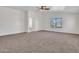 Main bedroom with carpet, ceiling fan and ensuite bath at 8312 W Pioneer St, Tolleson, AZ 85353