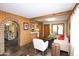 Living room with wood walls, and a view of the kitchen at 2023 W Rancho Dr, Phoenix, AZ 85015