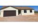 Newly built home with a brown garage door and light-colored exterior at 4629 N 334Th Ave, Tonopah, AZ 85354