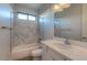 Bathroom with a bathtub, marble-look shower, and vanity at 4629 N 334Th Ave, Tonopah, AZ 85354