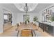Elegant dining room with a rustic wood table and modern lighting fixture at 9501 N 52Nd St, Paradise Valley, AZ 85253