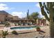 Community pool with surrounding lounge chairs and desert landscaping at 38065 N Cave Creek Rd # 4, Cave Creek, AZ 85331