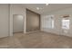 Living room with wood-look floors, a door to the backyard, and accent wall at 10910 E Oro Ave, Mesa, AZ 85212