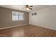 Bedroom with hardwood floors, ceiling fan and neutral walls at 10910 E Oro Ave, Mesa, AZ 85212
