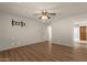 Bedroom with hardwood floors, ceiling fan, and access to bathroom at 10910 E Oro Ave, Mesa, AZ 85212