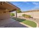 Covered patio and spacious backyard with artificial turf and gravel at 10910 E Oro Ave, Mesa, AZ 85212