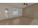 Bright living room with wood floors, plantation shutters and backyard access at 10910 E Oro Ave, Mesa, AZ 85212
