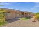 Home exterior showcasing a covered patio and spacious backyard at 10910 E Oro Ave, Mesa, AZ 85212