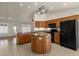 Kitchen with island, stainless steel appliances, and wood cabinets at 10910 E Oro Ave, Mesa, AZ 85212