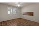 Charming bedroom with wood flooring, a ceiling fan, and window shutters at 10910 E Oro Ave, Mesa, AZ 85212