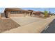 Three-car garage and driveway, desert landscaping at 10910 E Oro Ave, Mesa, AZ 85212