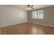 Spacious bedroom with hardwood floors and ceiling fan at 10910 E Oro Ave, Mesa, AZ 85212