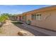 Home exterior with a pathway leading to a grassy backyard area at 10910 E Oro Ave, Mesa, AZ 85212