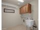 Laundry room with cabinets and utility sink at 10910 E Oro Ave, Mesa, AZ 85212