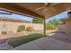 Covered patio overlooks a desert landscape with artificial turf and gravel at 10910 E Oro Ave, Mesa, AZ 85212