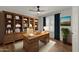 Spacious home office with wooden desk and bookcase at 10910 E Oro Ave, Mesa, AZ 85212