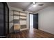 Bedroom with built-in shelving and hardwood floors at 4422 N 75Th St # 4011, Scottsdale, AZ 85251
