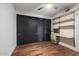 Bedroom with hardwood floors, built-in shelving and closet at 4422 N 75Th St # 4011, Scottsdale, AZ 85251