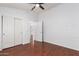 Bright bedroom with wood flooring, double doors and ceiling fan at 2402 E 5Th St # 1481, Tempe, AZ 85288