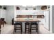 Granite island kitchen with white cabinets and stainless steel appliances at 5839 E Jensen St, Mesa, AZ 85205
