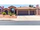 Tan two-story house with brown garage doors and cacti landscaping at 5839 E Jensen St, Mesa, AZ 85205
