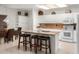 Bright kitchen boasts granite countertops, white cabinetry, and an island at 5839 E Jensen St, Mesa, AZ 85205