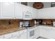 White kitchen cabinets, granite counters, and black appliances at 5839 E Jensen St, Mesa, AZ 85205