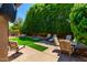 Landscaped backyard with artificial turf and patio furniture at 5839 E Jensen St, Mesa, AZ 85205