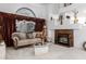 Living room featuring a beige couch, fireplace, and large windows at 5839 E Jensen St, Mesa, AZ 85205