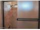 Shower with tile surround and glass door at 17808 N 57Th Pl, Scottsdale, AZ 85254