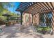 Outdoor kitchen with built-in grill, pergola, and seating area at 17808 N 57Th Pl, Scottsdale, AZ 85254
