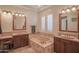 Elegant bathroom with double sinks, soaking tub, and separate shower at 17808 N 57Th Pl, Scottsdale, AZ 85254