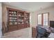Spacious home office with built-in shelving and a large desk at 17808 N 57Th Pl, Scottsdale, AZ 85254