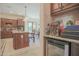 Kitchen with island, wine cooler, and access to the dining area at 17808 N 57Th Pl, Scottsdale, AZ 85254