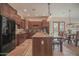 Kitchen boasts granite countertops, dark wood cabinets, and stainless steel appliances at 17808 N 57Th Pl, Scottsdale, AZ 85254