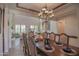 Open dining room with a large table and chandelier, view of living room at 17808 N 57Th Pl, Scottsdale, AZ 85254