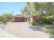Spanish style home with a large tree and brick driveway at 17808 N 57Th Pl, Scottsdale, AZ 85254