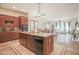 Open kitchen with large island, granite countertops, and adjacent dining area at 17808 N 57Th Pl, Scottsdale, AZ 85254