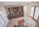 Bright home office with built-in shelving and a large desk, near French doors at 17808 N 57Th Pl, Scottsdale, AZ 85254