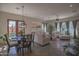 Bright dining area with a wooden table and chairs, adjacent to a living room at 17808 N 57Th Pl, Scottsdale, AZ 85254