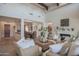 Spacious living room with high ceilings, exposed beams, and comfortable seating at 17808 N 57Th Pl, Scottsdale, AZ 85254